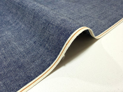Okayama Denim 4.5 oz Japanese indigo selvage chambray fabric with crisp texture and distinctive selvage edge.