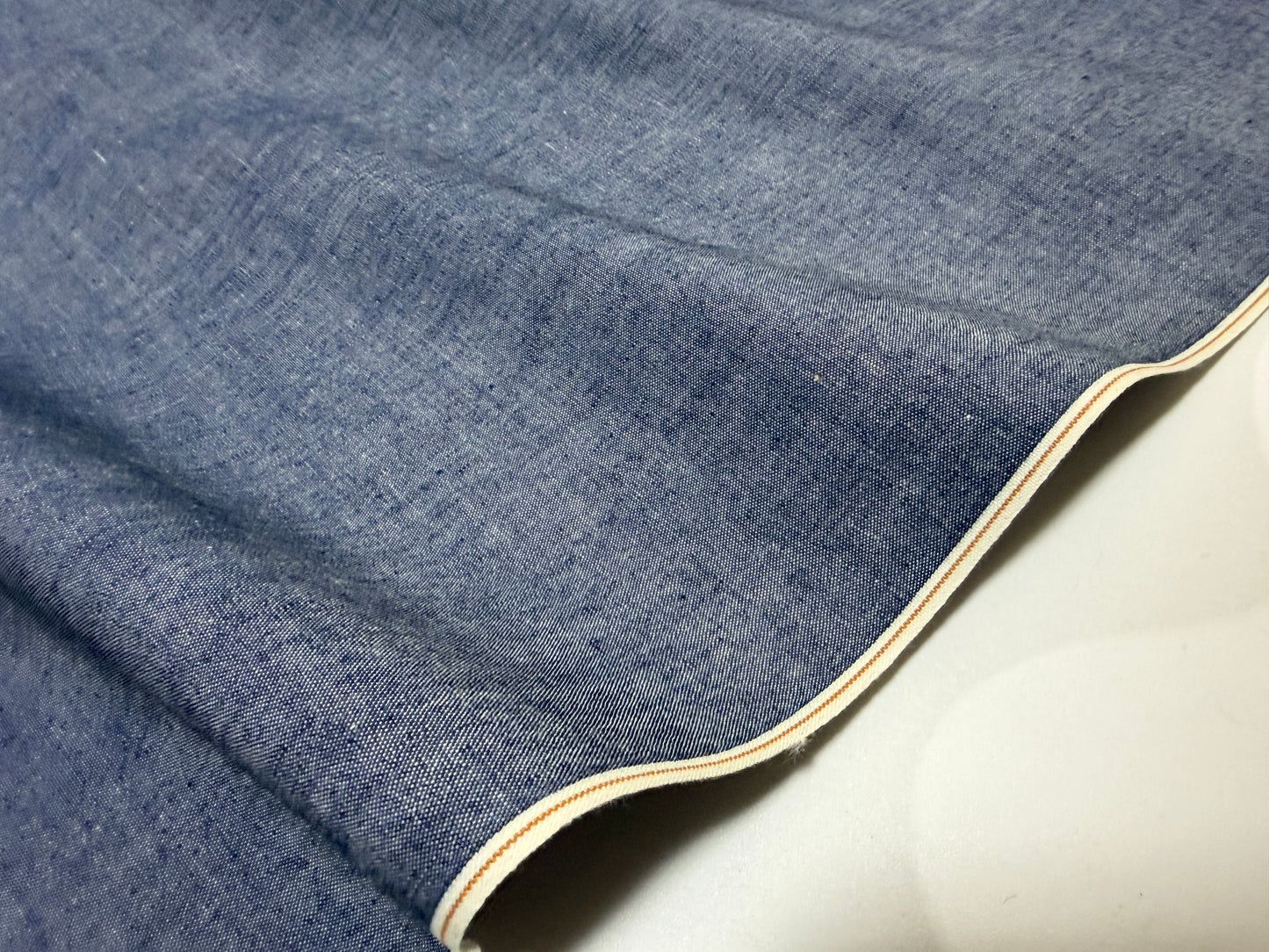 Okayama Denim 4.5 oz Japanese indigo selvage chambray fabric with crisp texture and selvedge edge.