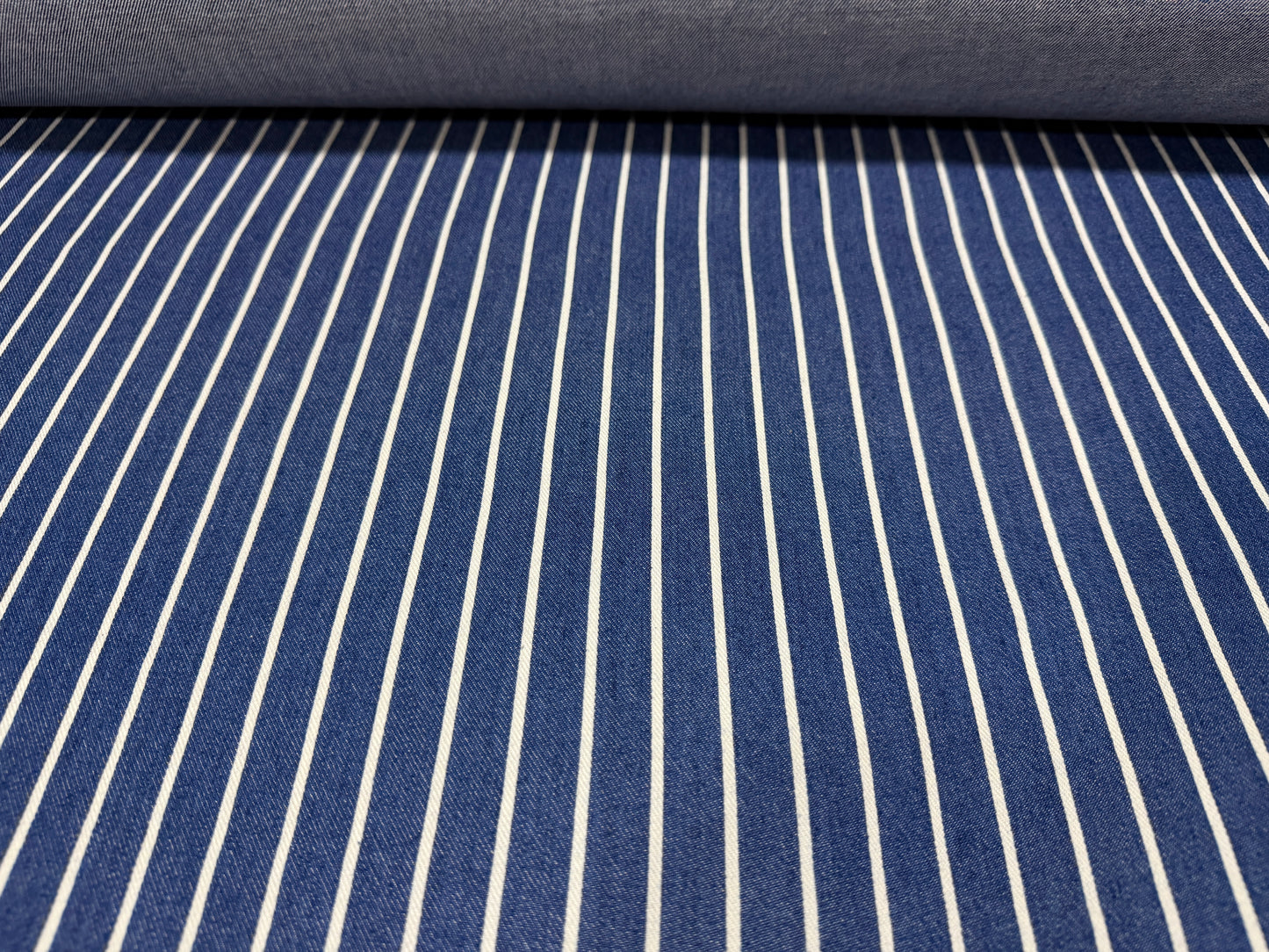 Okayama Denim fabric featuring blue and white striped pattern from Japanese indigo cotton discharge printing.
