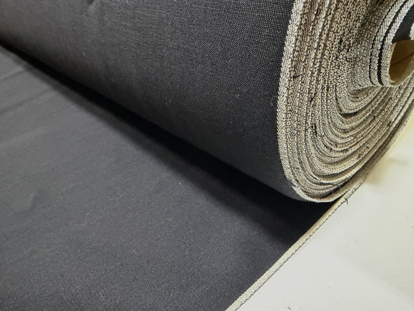 Okayama Denim fabric roll, 6.5 oz double-sided black shirt-weight fabric for elegant apparel.