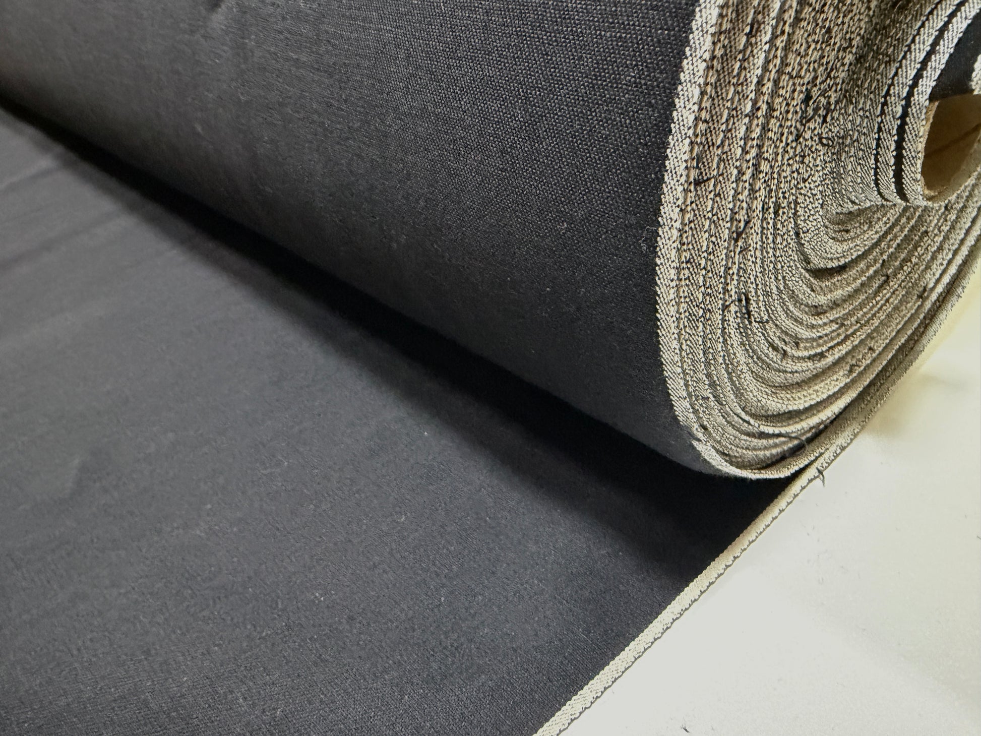 Okayama Denim fabric roll, 6.5 oz double-sided black shirt-weight fabric for elegant apparel.