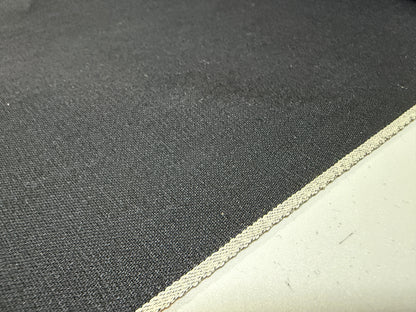 Okayama Denim 5 oz double-sided black shirt-weight fabric with a selvedge edge, showcasing its soft texture.