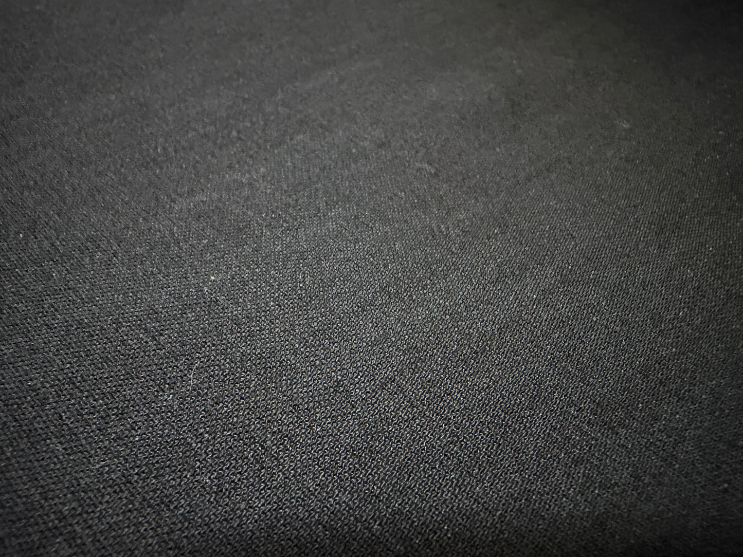 Close-up of Okayama Fabric, a 6.5 oz double-sided black shirt-weight fabric, perfect for refined shirts.