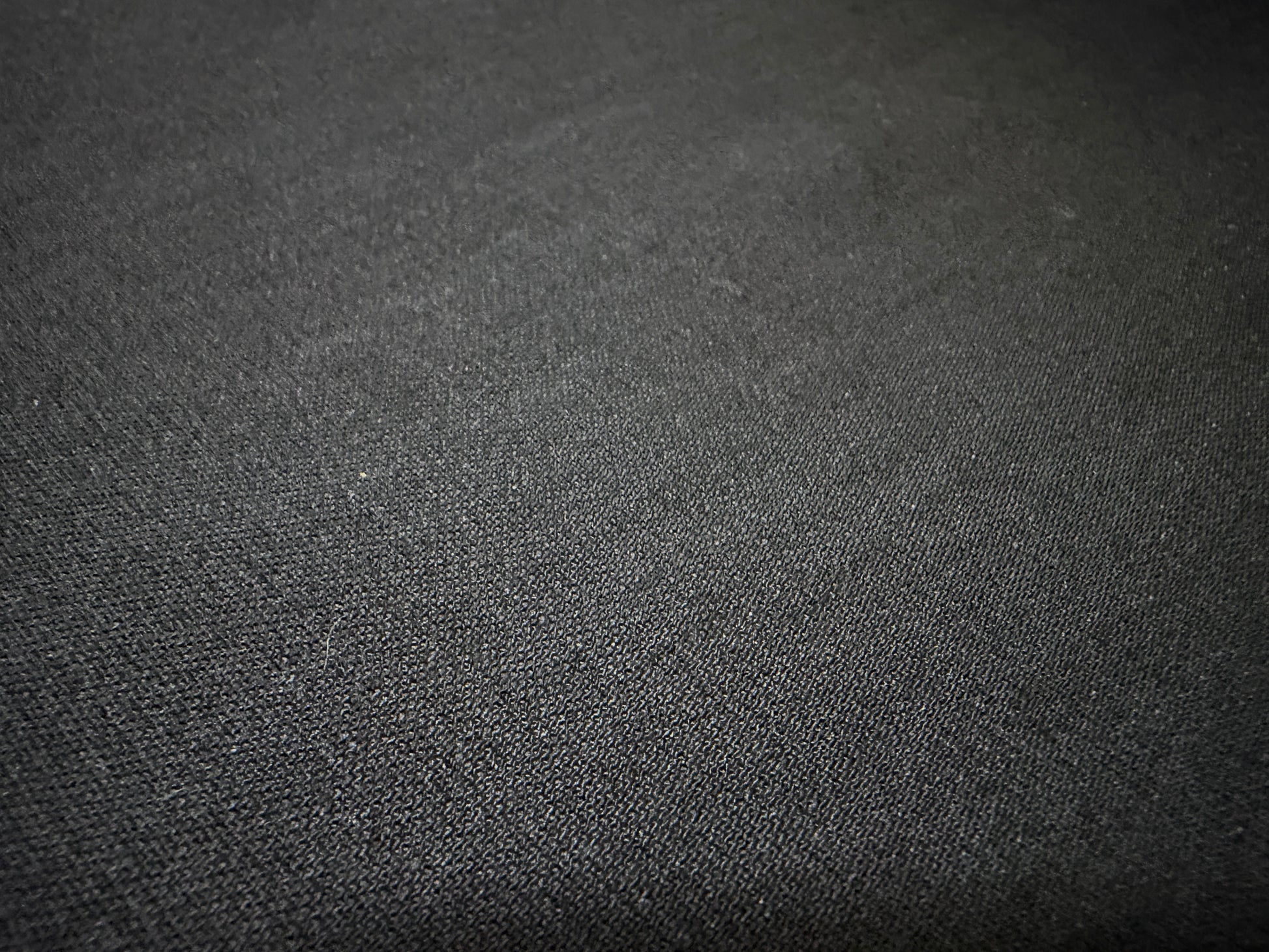 Close-up of Okayama Fabric, a 6.5 oz double-sided black shirt-weight fabric, perfect for refined shirts.