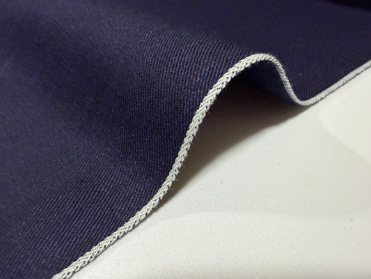 Close-up of Okayama Fabric, a 6.5 oz double-sided indigo shirt-weight fabric with a clean selvedge edge.