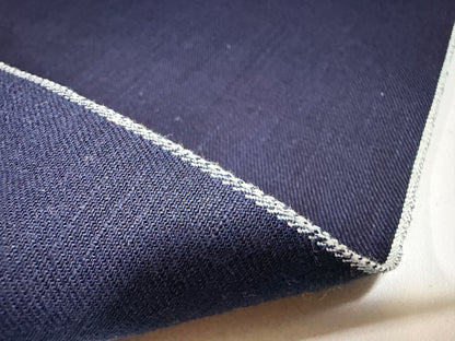 Okayama Fabric showing the texture and selvedge edge of 6.5 oz double-sided indigo shirt-weight fabric.