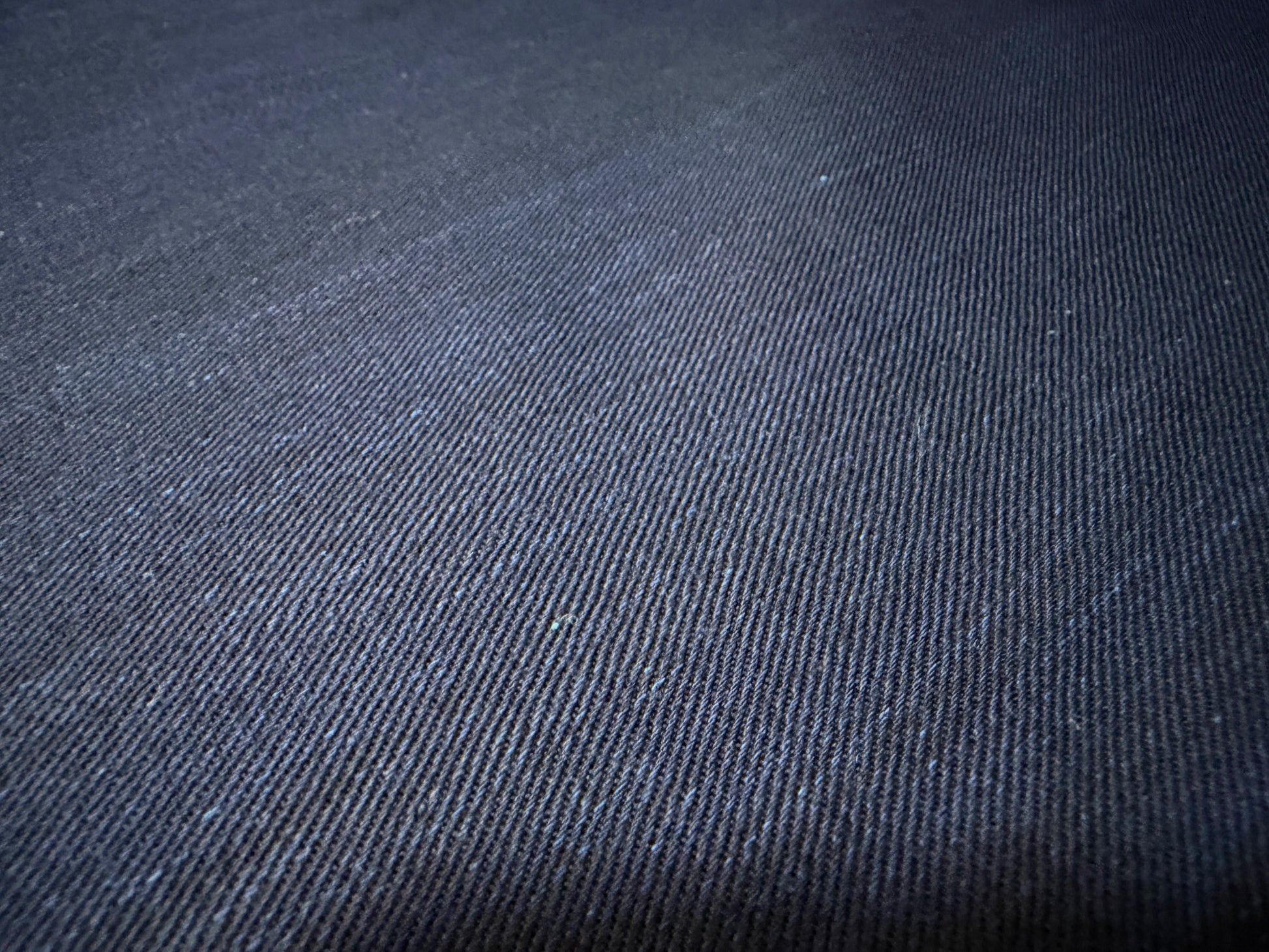 Okayama Denim fabric texture showcasing dark indigo color and soft surface, perfect for shirt-making.
