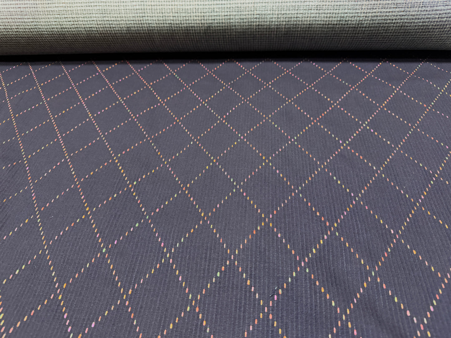 Okayama Denim 7 oz Sashiko fabric featuring colorful diamond stitching and a soft texture, ideal for unique projects.