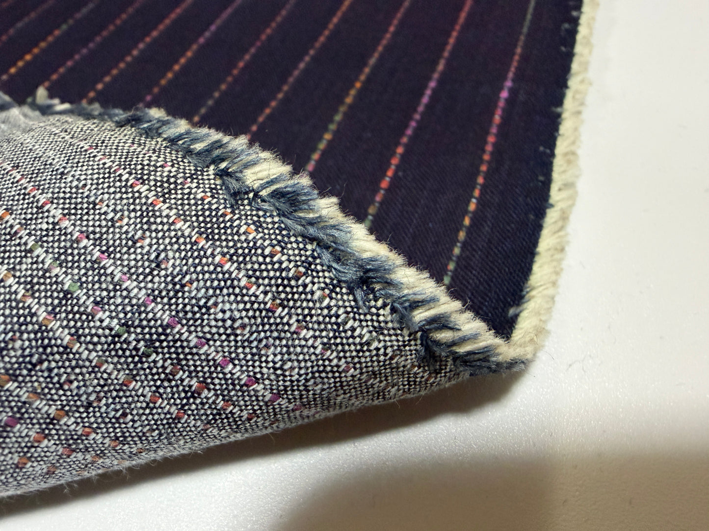 Okayama Denim 7 oz Sashiko 'Stripes' cotton fabric showcasing colorful stitching and unique texture by the yard.