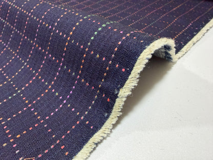 Okayama Denim fabric showcasing colorful multi-color stitching on a navy Sashiko grid pattern.