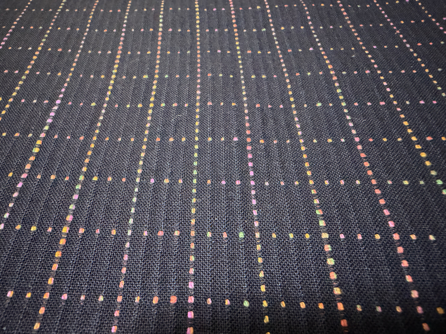 Okayama Denim 7 oz Sashiko "Grid" Cotton Fabric featuring colorful stitching on a dark background.
