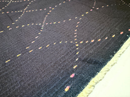 Okayama Denim 7 oz Sashiko fabric displaying colorful stitching on a dark background, perfect for unique textile projects.