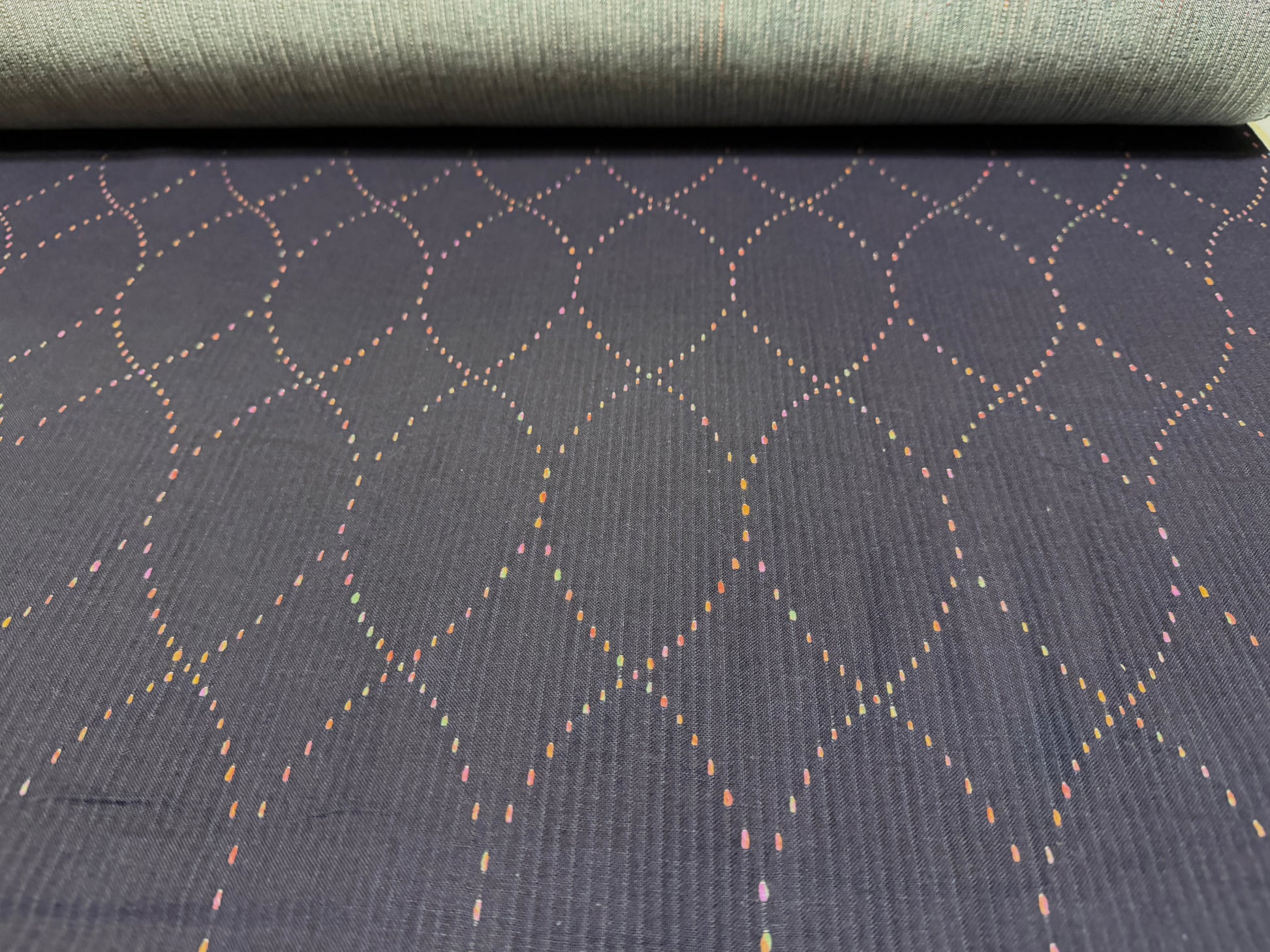 Okayama Denim 7 oz Sashiko fabric featuring colorful stitching in diamond lattice pattern, lightweight and unique.