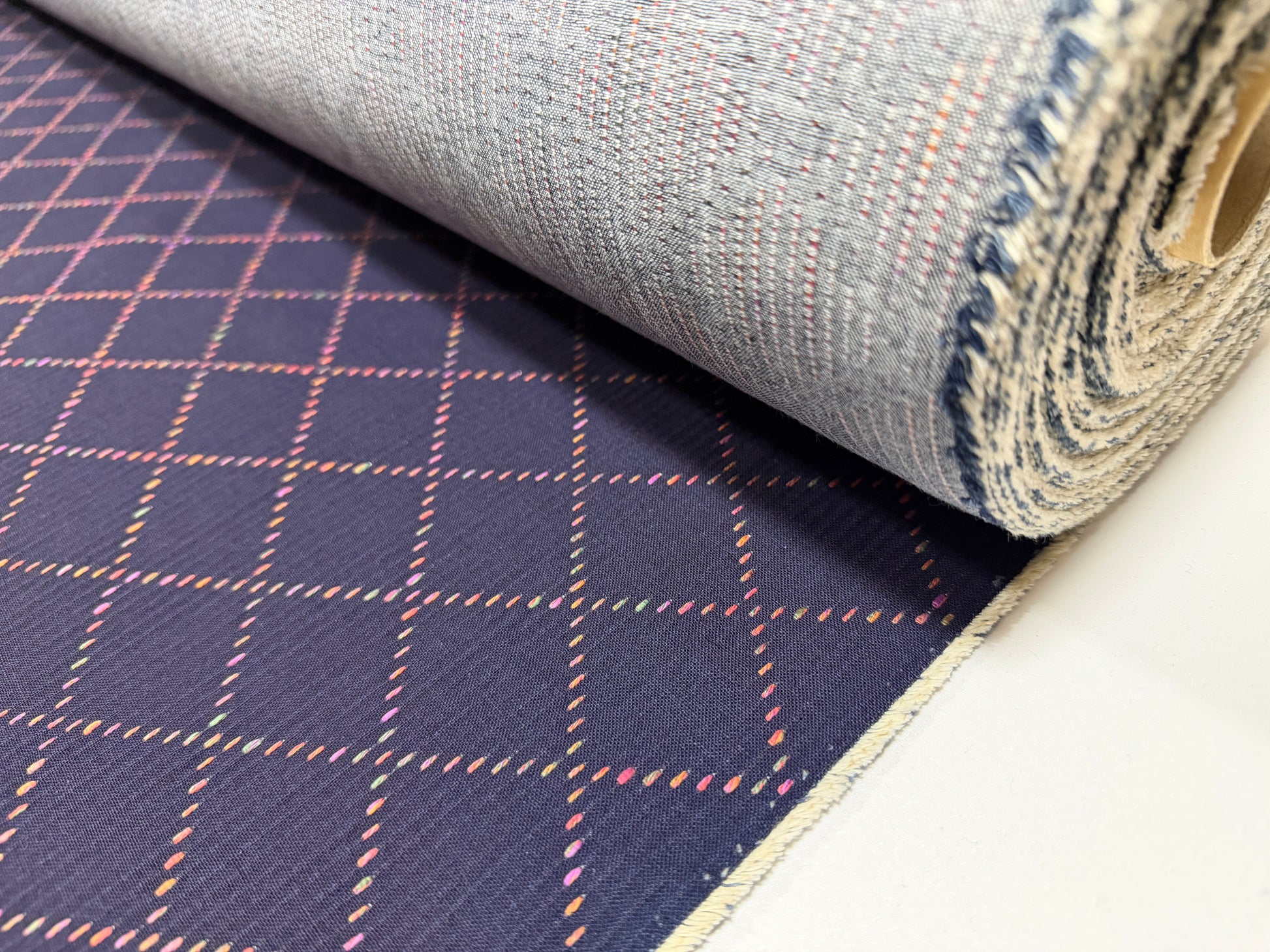Okayama Denim 7 oz Sashiko fabric featuring colorful stitching and a unique small diamond pattern.