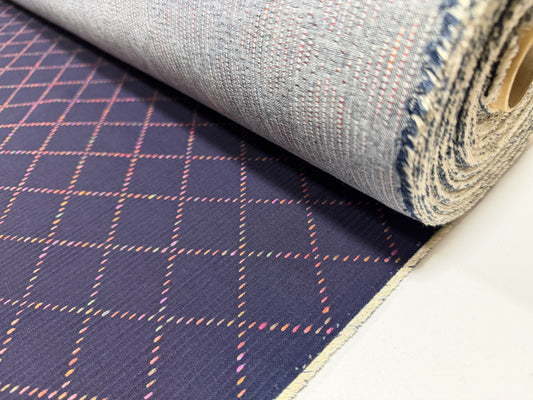 Okayama Denim 7 oz Sashiko fabric featuring colorful stitching and a unique small diamond pattern.