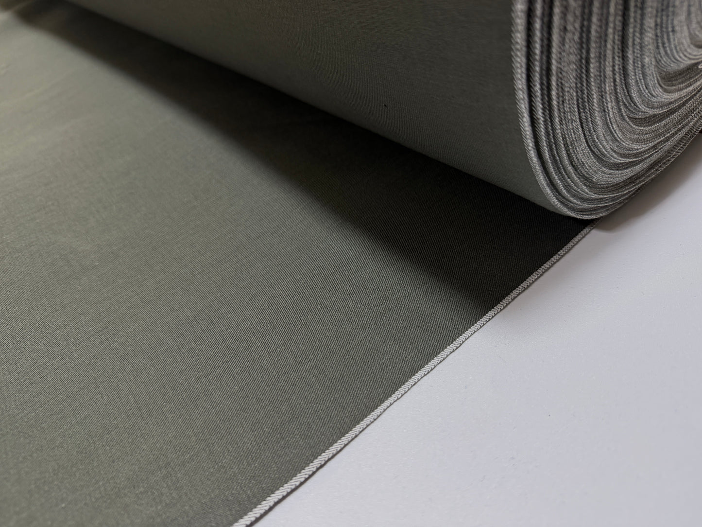 Okayama Denim 7.5 oz Japanese cotton olive dungaree fabric roll by the yard, featuring a traditional selvage edge.