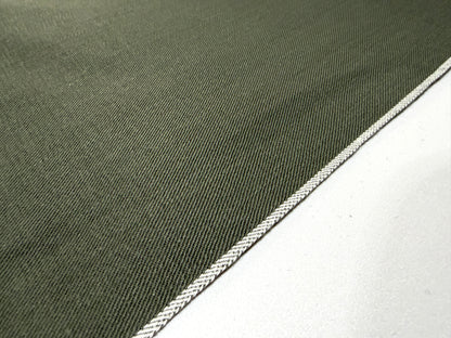 Okayama Denim 7.5 oz Japanese cotton olive dungaree fabric showing traditional selvage edge detail.