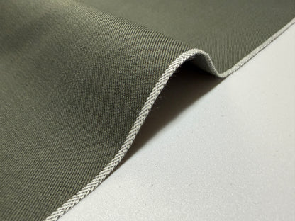 Okayama Denim 7.5 oz Japanese cotton olive dungaree fabric showcasing selvage edge.