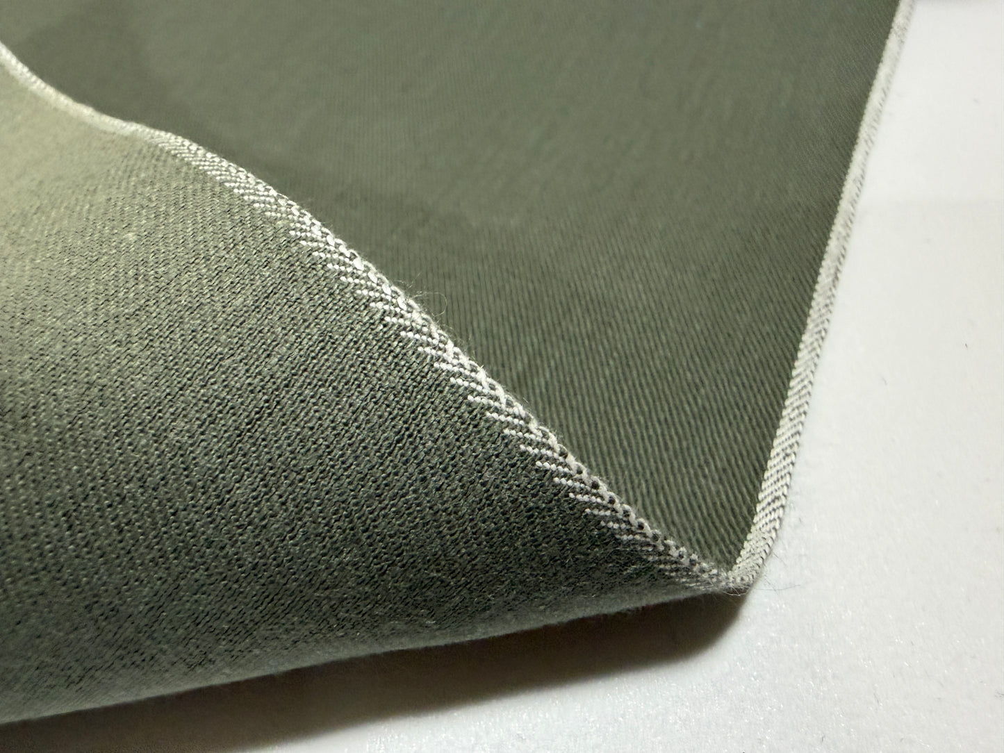 Okayama Denim 7.5 oz Japanese cotton olive dungaree fabric showcasing selvage edge.