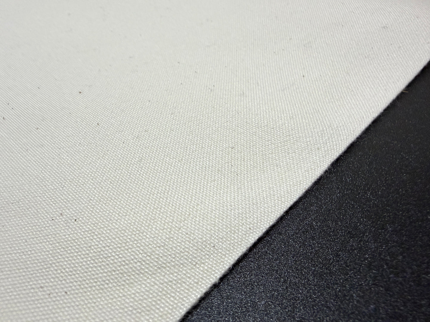 Close-up of Okayama Canvas, a 10 oz Japanese cotton ecru color fabric, ideal for bags and outerwear.