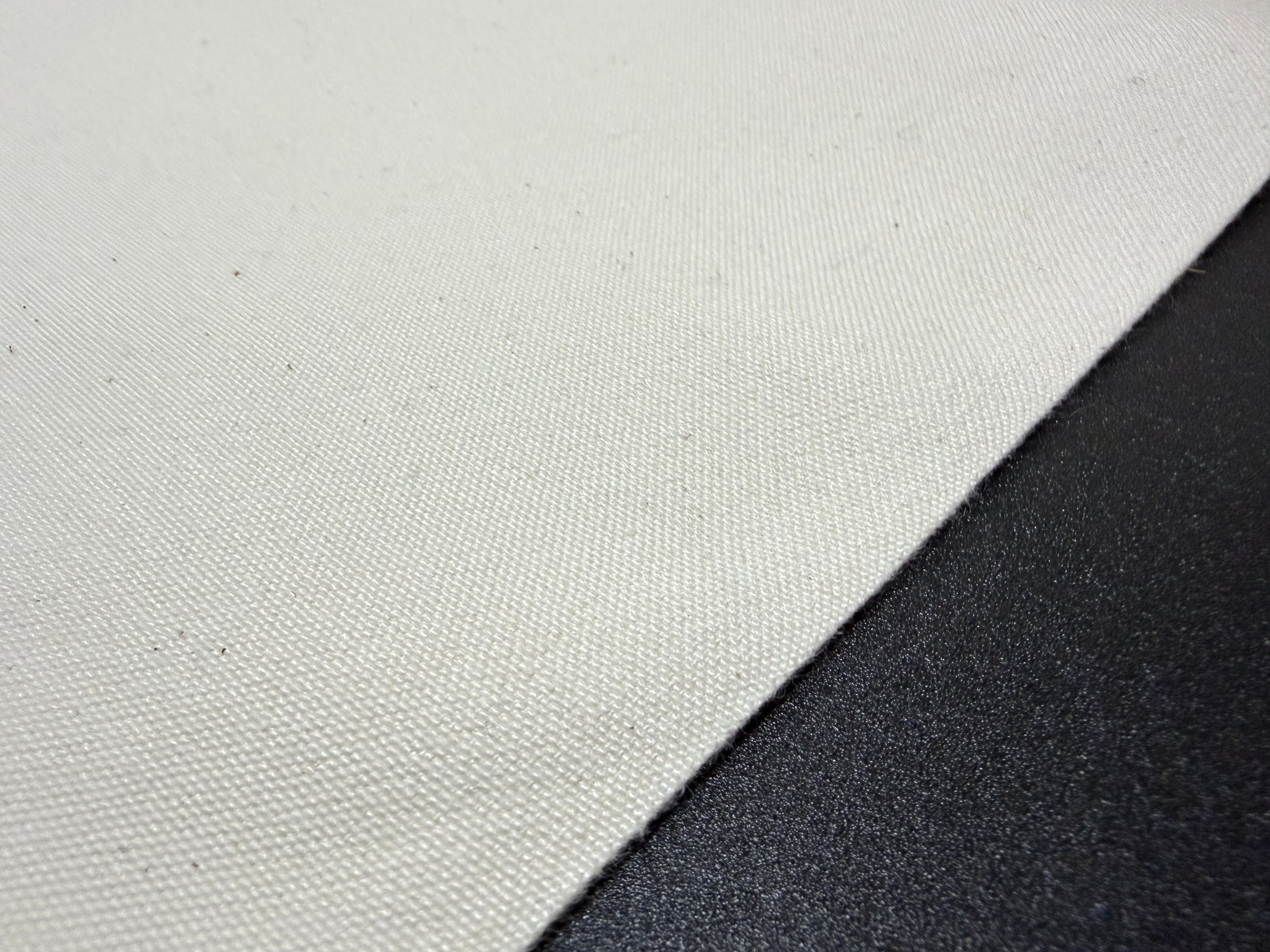 Close-up of Okayama Canvas, a 10 oz Japanese cotton ecru color fabric, ideal for bags and outerwear.