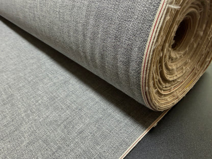 Okayama Denim 6 oz Japanese Gray chambray fabric with red selvage rolled up for purchase.