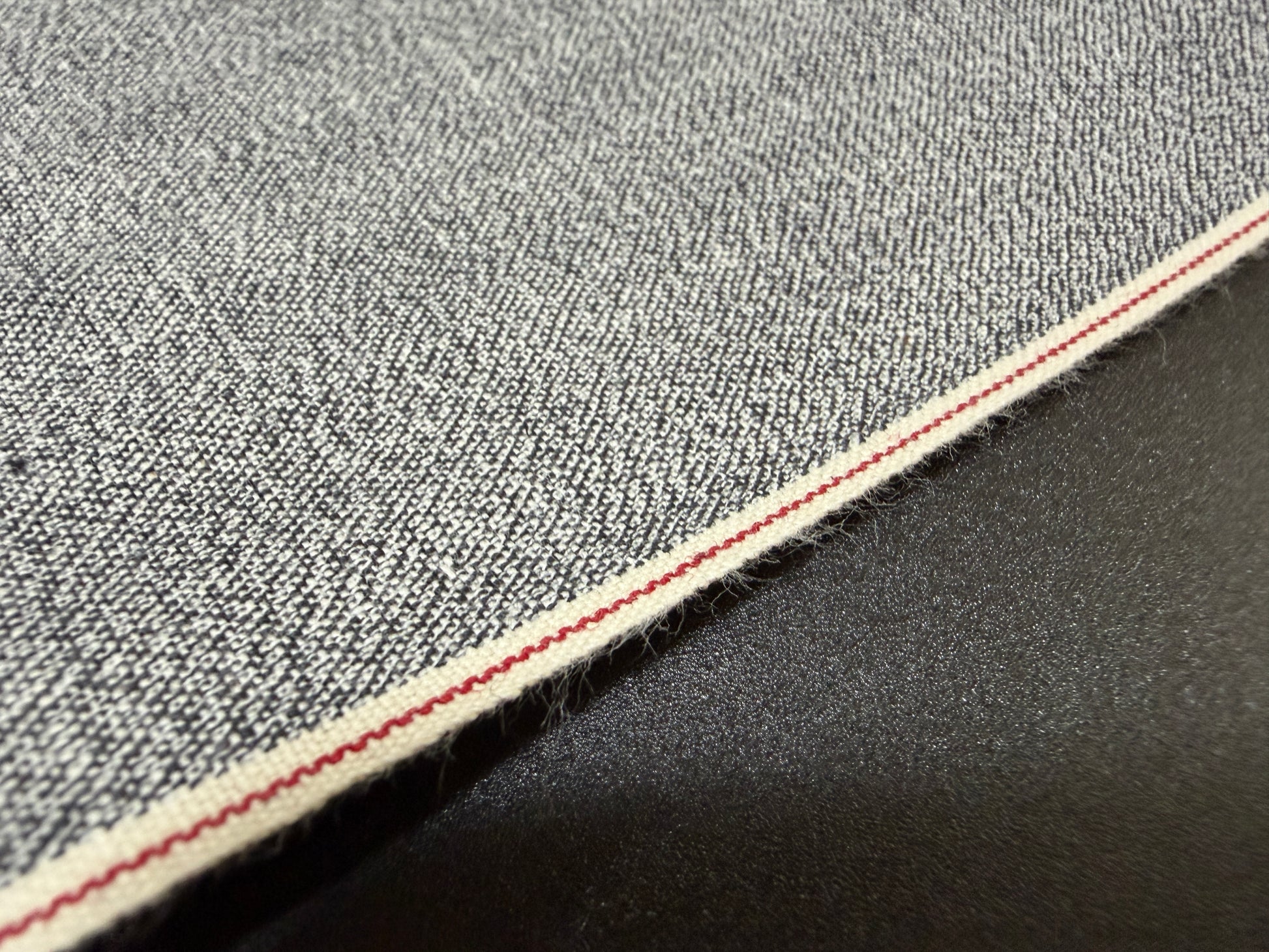 Okayama Denim 6 oz Japanese Gray Chambray fabric featuring red selvage by the yard.