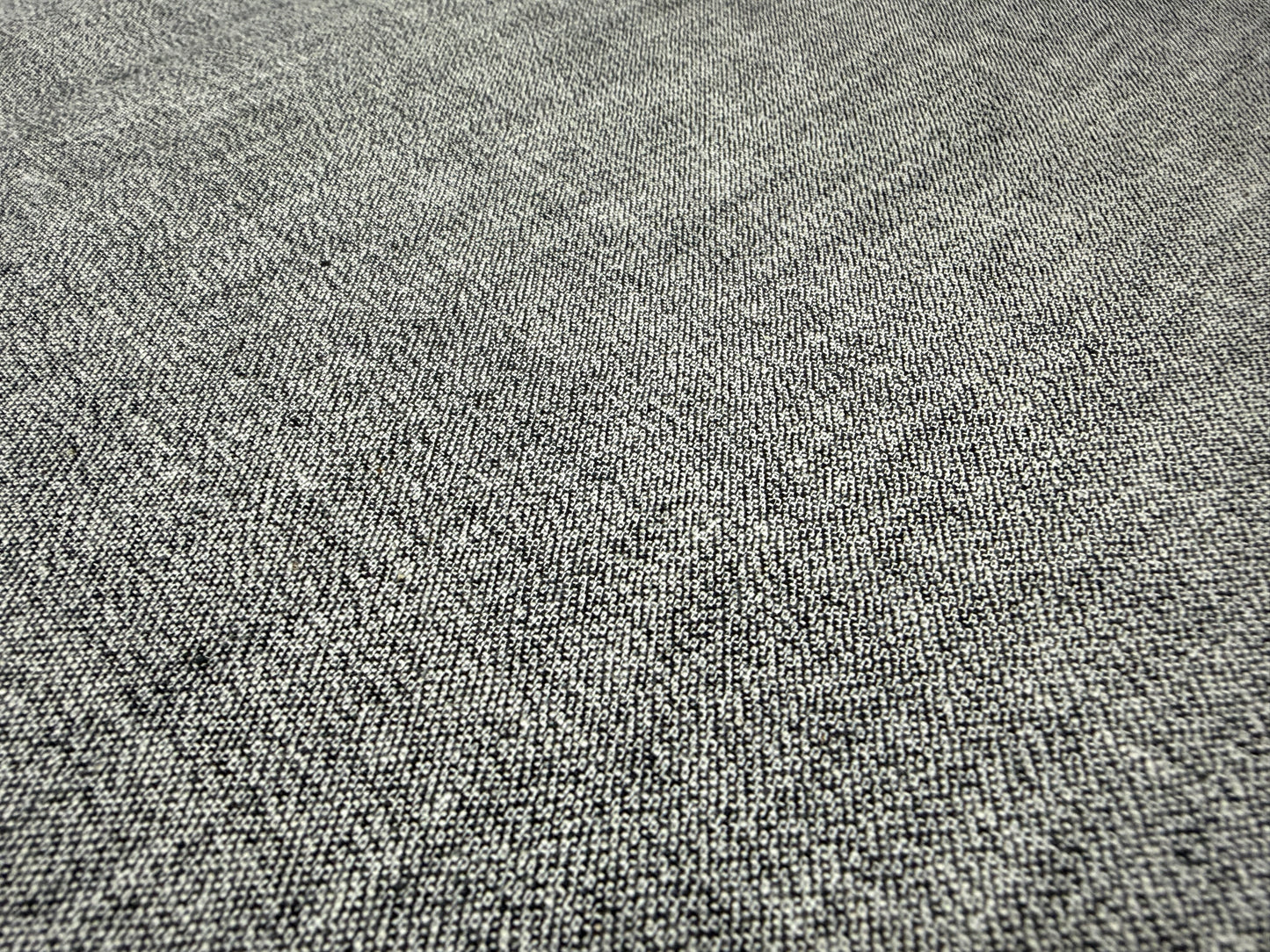 Okayama Denim 6 oz Japanese gray chambray fabric texture close-up on a flat surface.