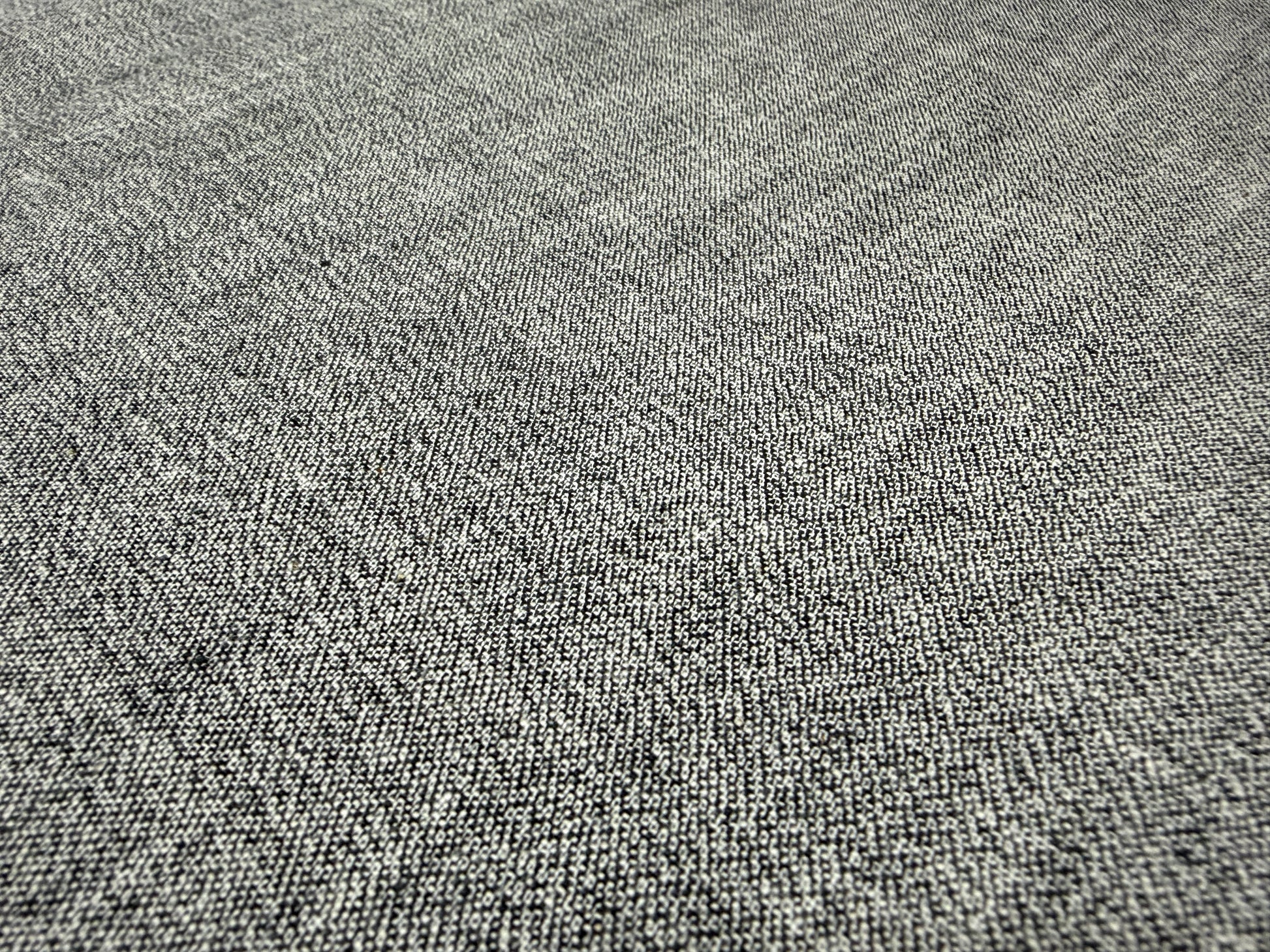 Okayama Denim 6 oz Japanese gray chambray fabric texture close-up on a flat surface.