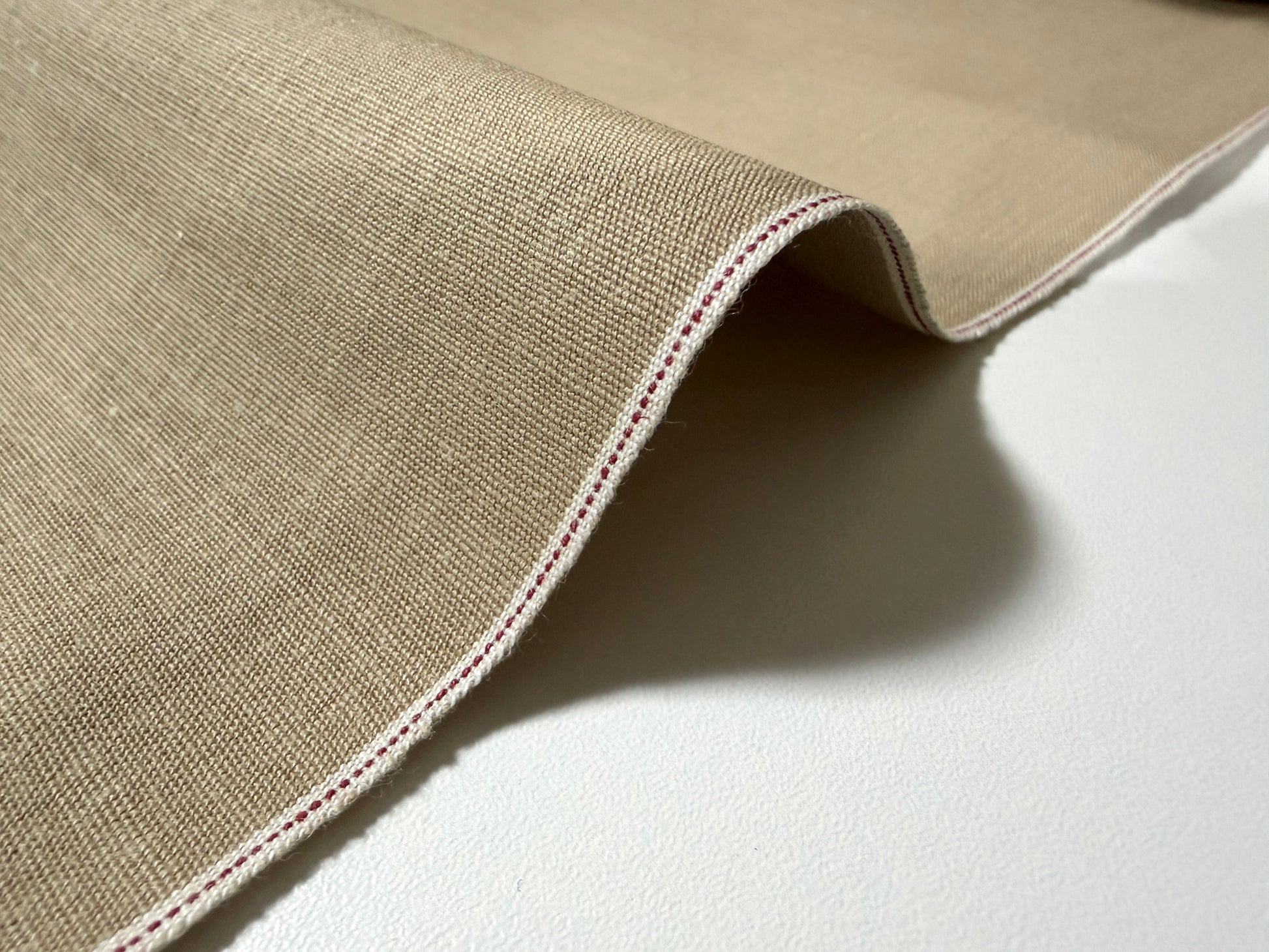 Okayama Denim 8 oz Japanese cotton beige dungaree fabric showing selvage edge detail.