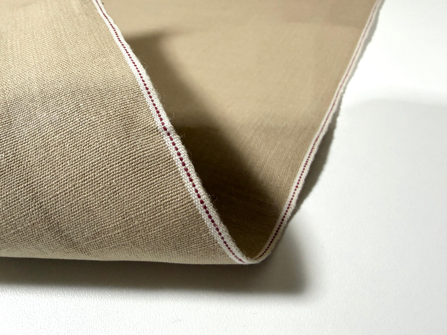 Okayama Denim beige dungaree fabric with traditional selvage edge, showcasing soft texture and quality craftsmanship.