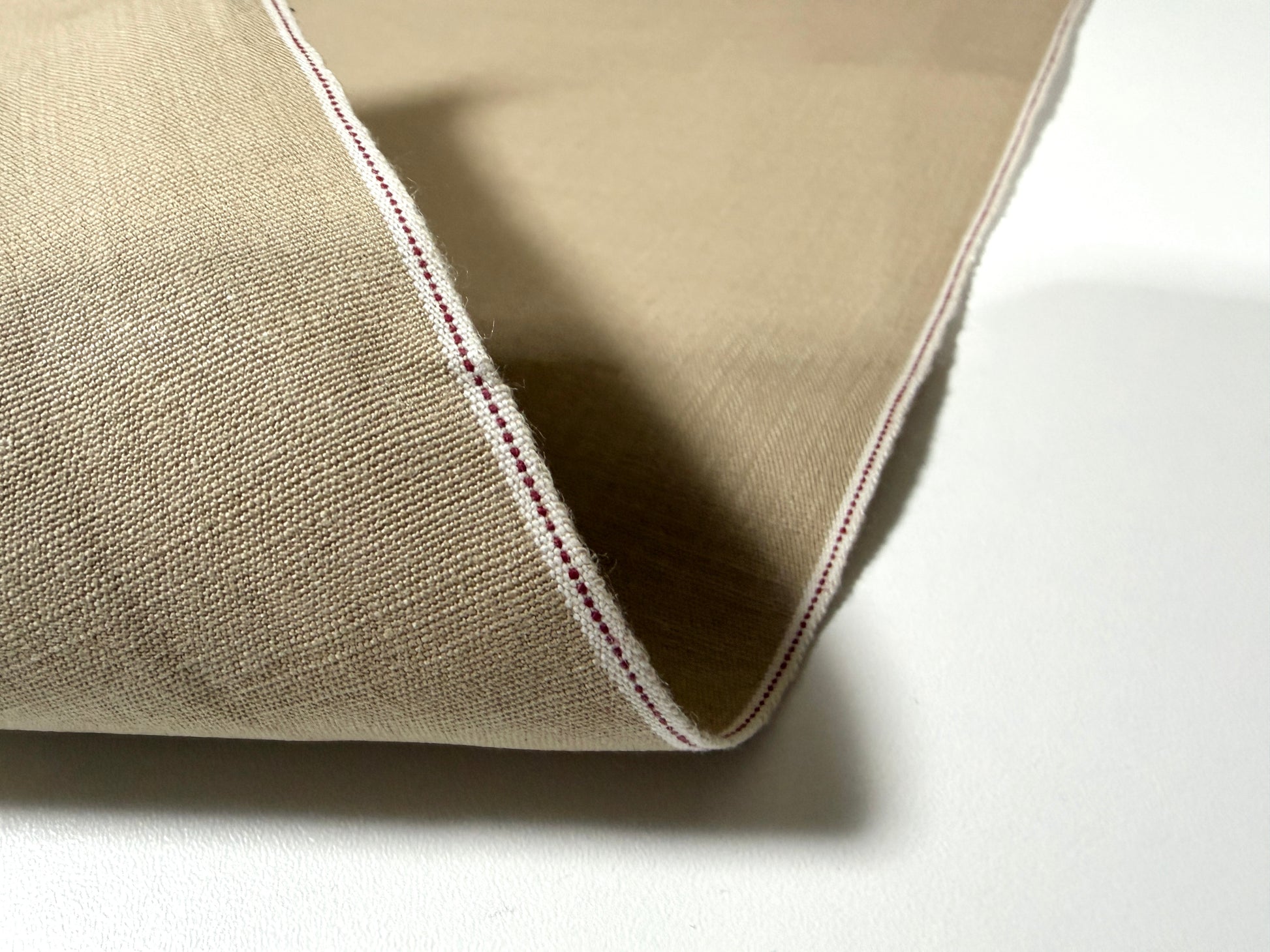 Okayama Denim beige dungaree fabric with traditional selvage edge, showcasing soft texture and quality craftsmanship.