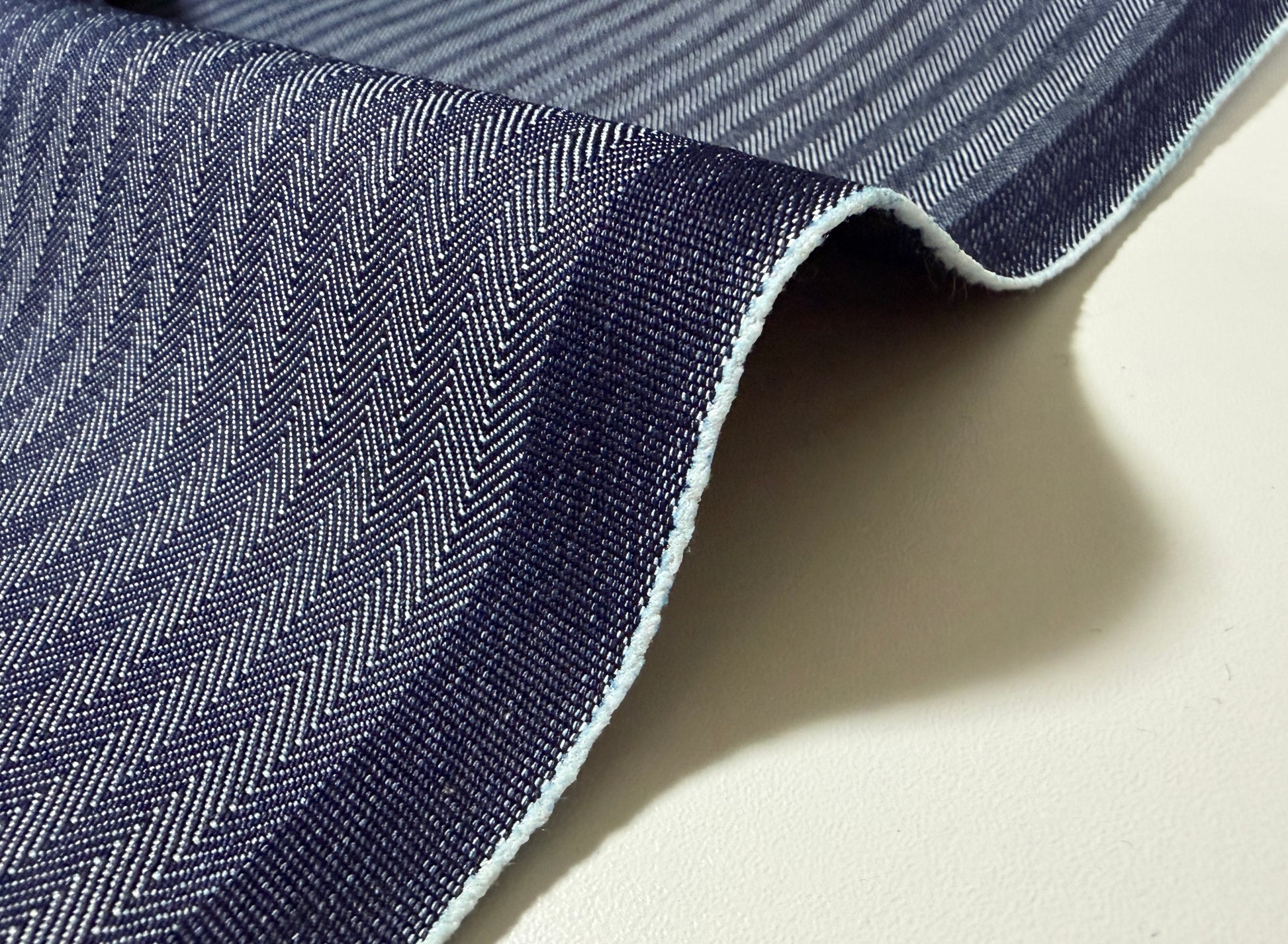Okayama Denim 10.5 oz Japanese cotton herringbone stripe blue fabric showcasing its rich texture and classic pattern.