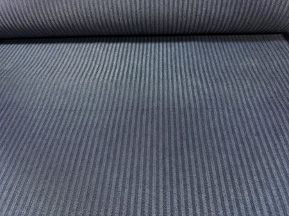 Okayama Denim fabric showing navy herringbone stripe pattern on a roll, 10.5 oz Japanese cotton material.
