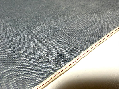 Okayama Denim Japanese grayish-blue slub chambray fabric with red selvage detail.