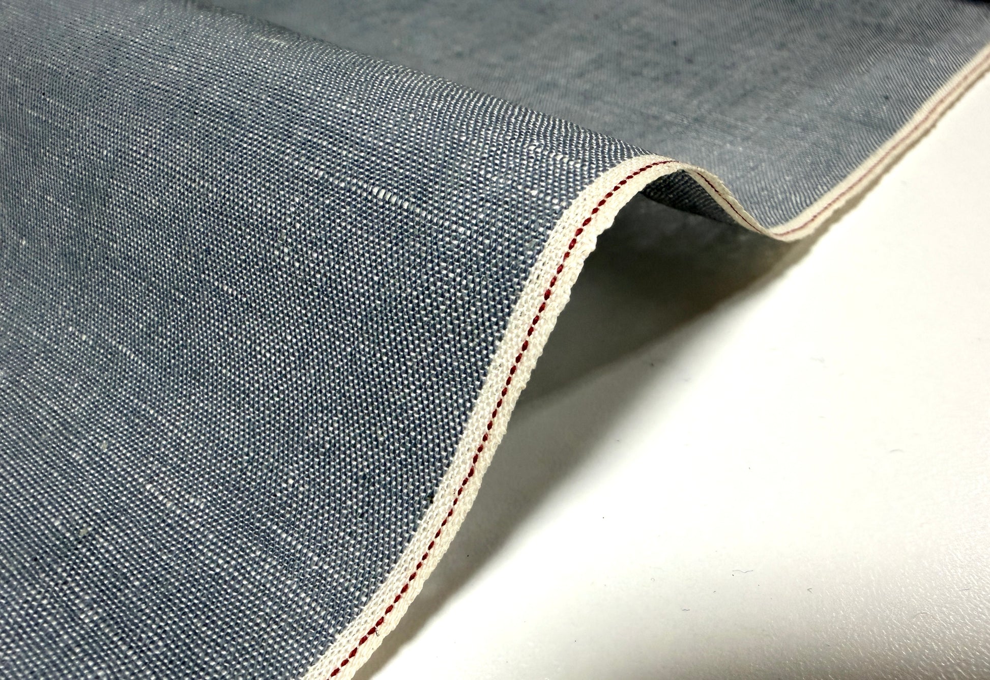 Okayama Denim grayish-blue chambray fabric showcasing red selvage detail.