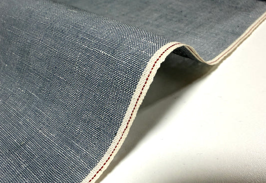 Okayama Denim grayish-blue chambray fabric showcasing red selvage detail.