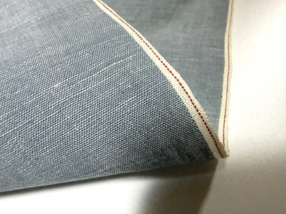 Okayama Denim fabric detail featuring Japanese grayish-blue chambray and red selvage, perfect for stylish apparel.