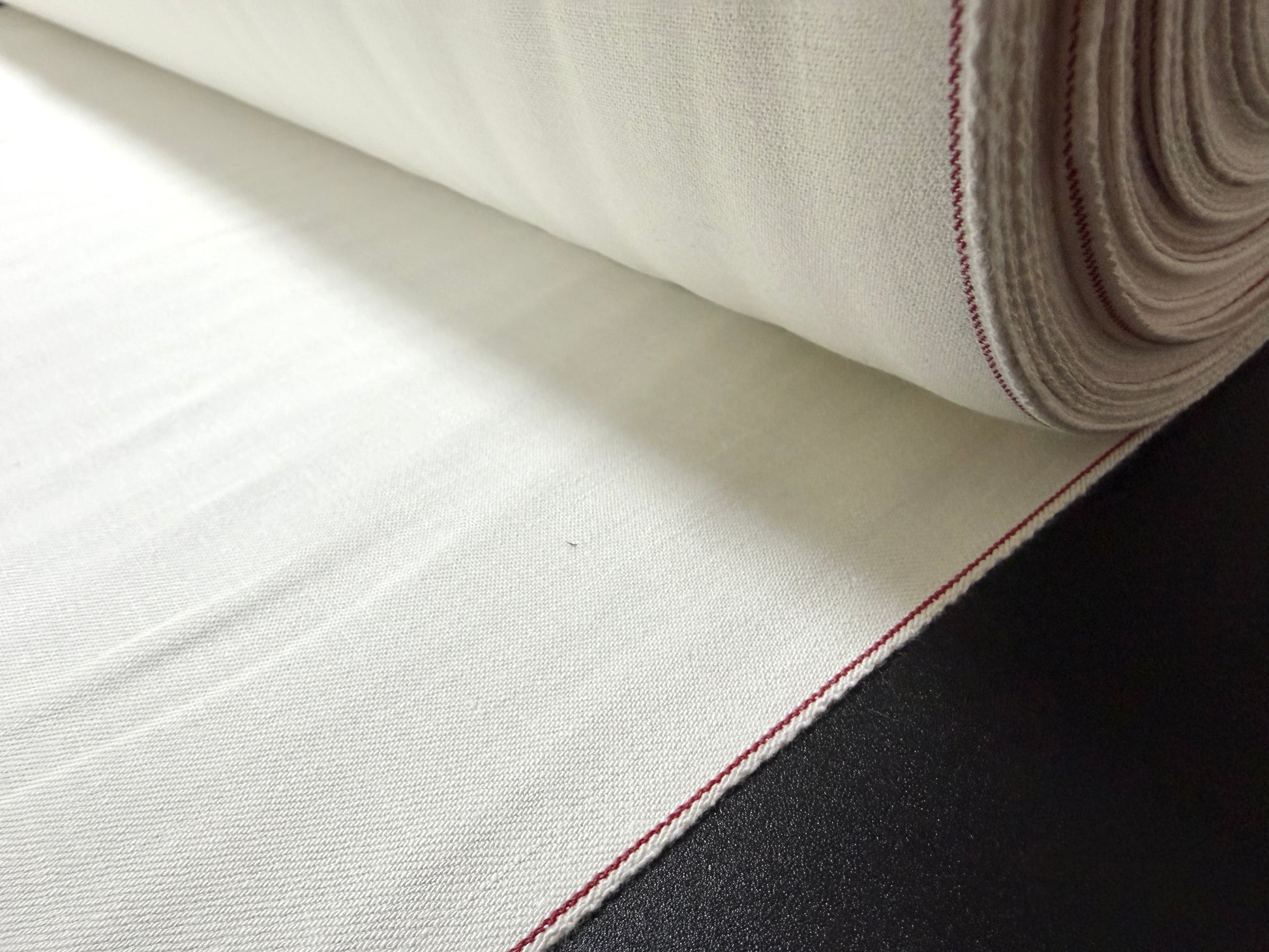 Okayama Denim rare 9.5 oz selvage plane weave cotton fabric by the yard, showcasing a soft natural texture.