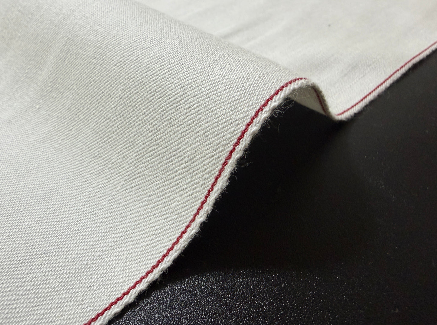Okayama Denim rare 9.5 oz selvage plane weave cotton fabric with red selvedge edge.