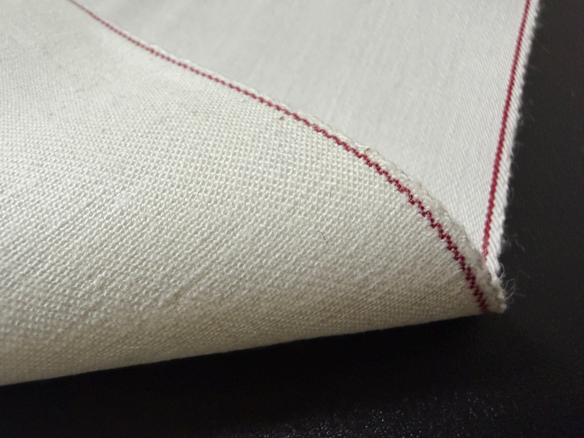 Okayama Denim rare 9.5 oz selvage plane weave cotton fabric close-up with red selvedge edge