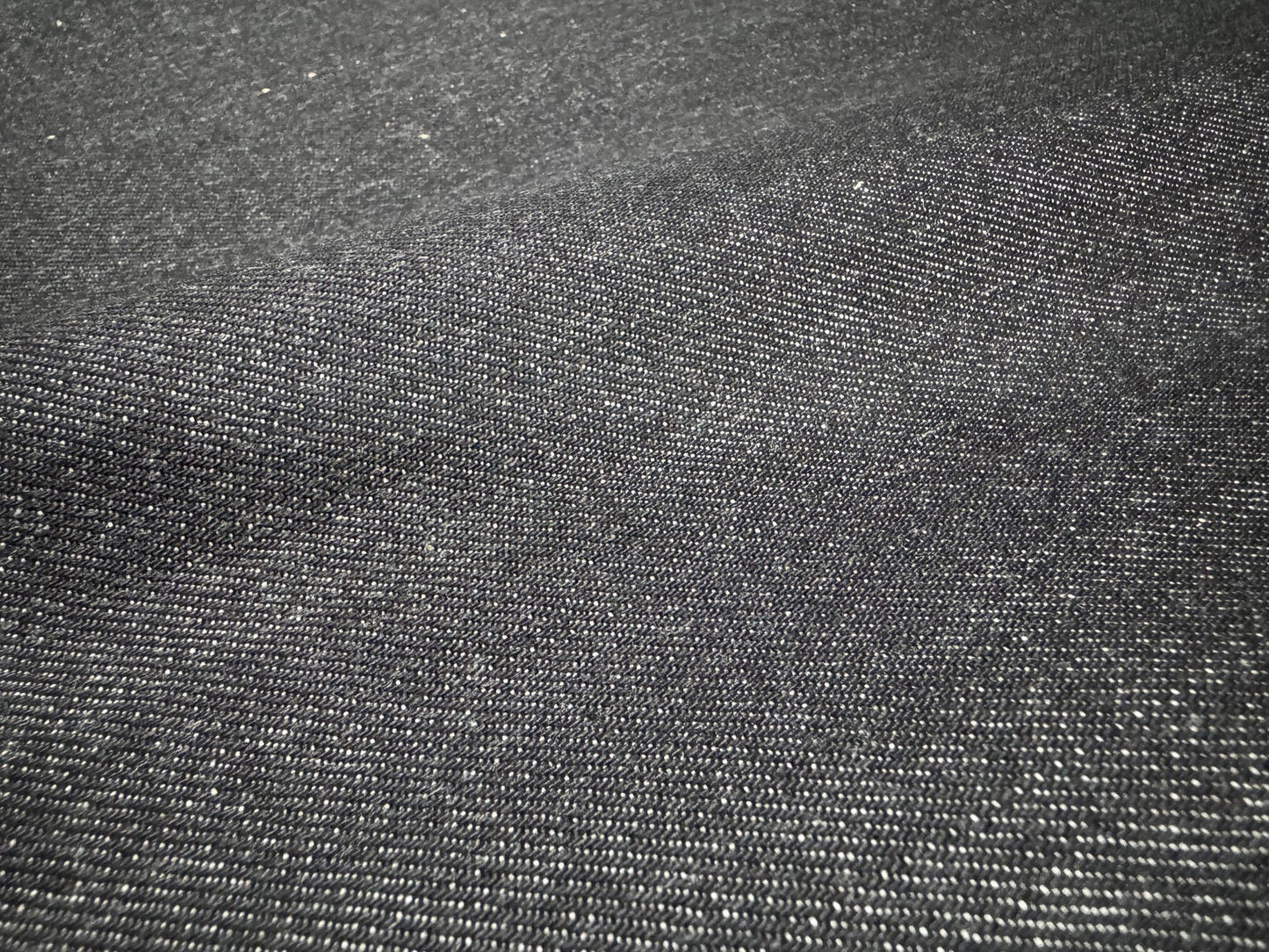 Close-up of Okayama Denim 10.5 oz Japanese Cotton Black Selvage Denim fabric texture.