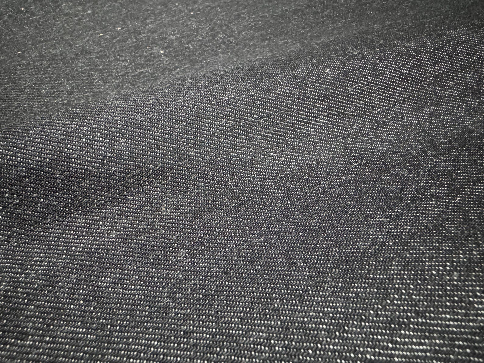 Close-up of Okayama Denim 10.5 oz Japanese Cotton Black Selvage Denim fabric texture.