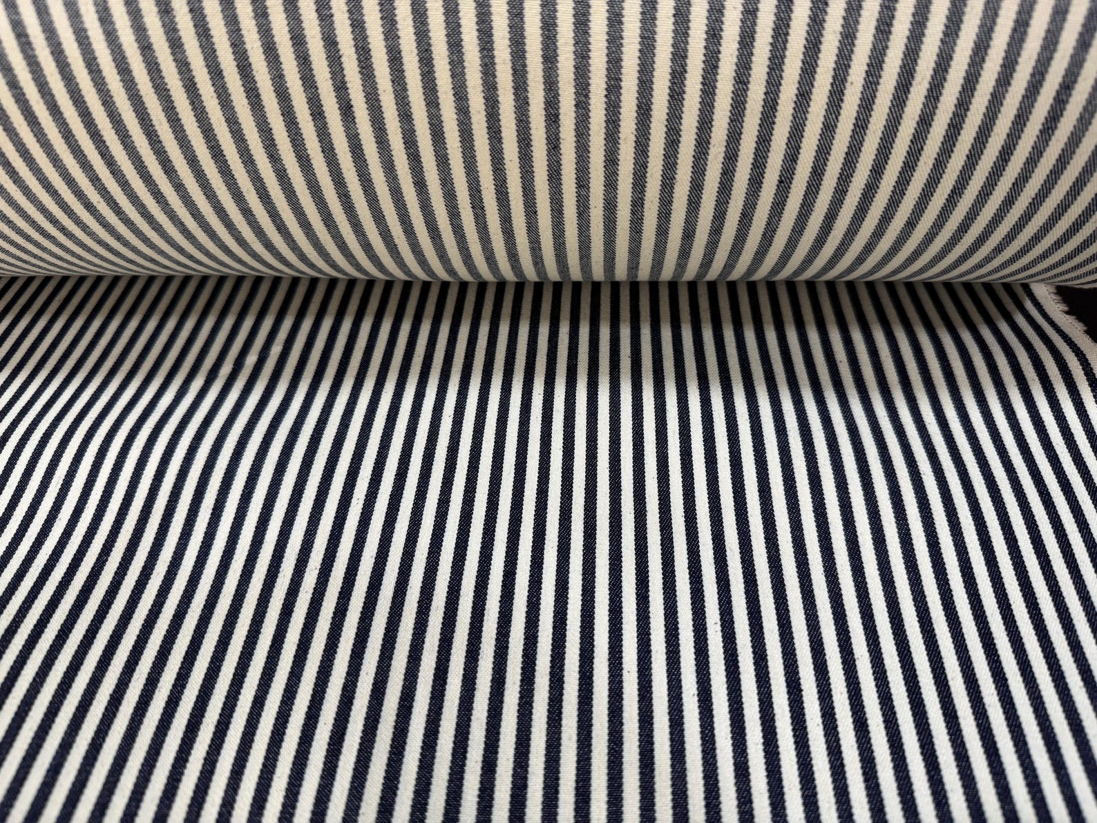 Okayama Denim fabric featuring a 10oz double width indigo hickory striped pattern, ideal for sewing and crafting.