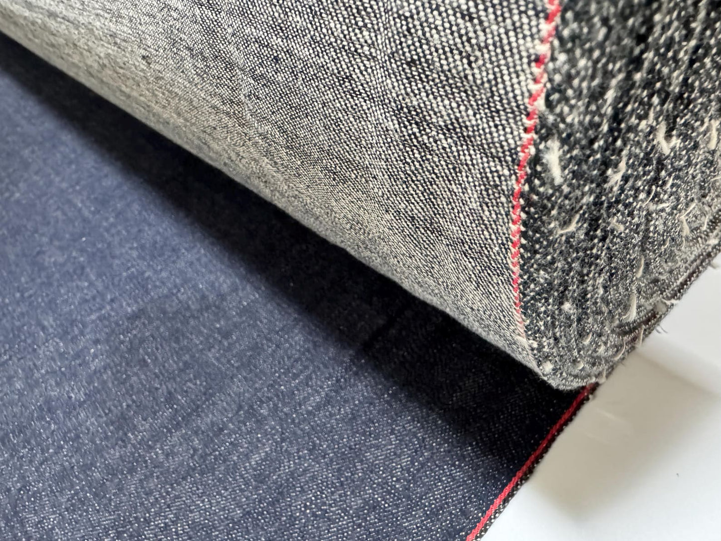 Okayama Denim 12.5 oz Japanese Indigo Kibata Selvage Denim fabric showcasing its rich texture and red selvage edge.