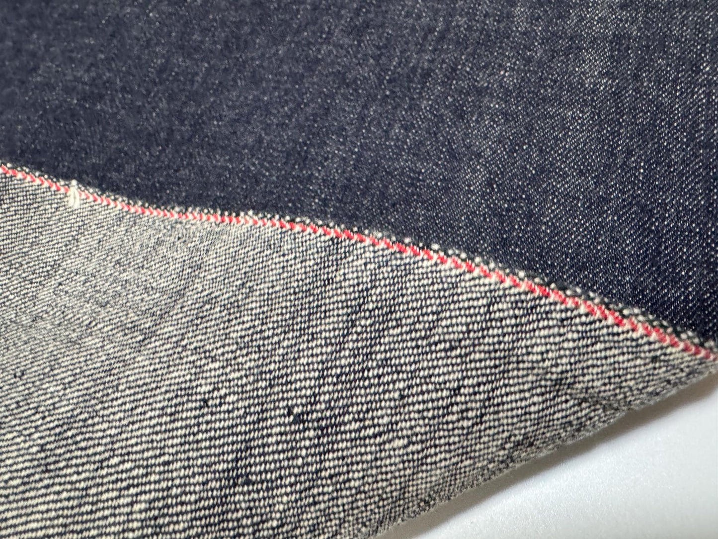 Okayama Denim | 12.5 oz Japanese Indigo Kibata Selvage Denim close-up showing texture and edge details.