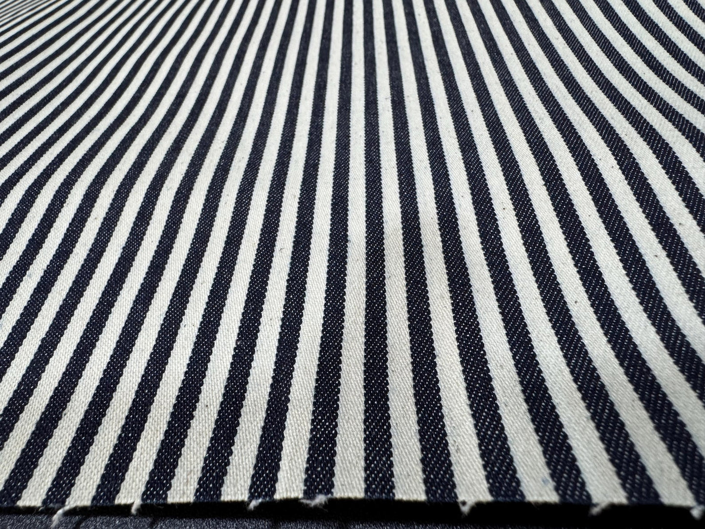 Close-up view of Okayama Denim fabric featuring navy and white stripes.