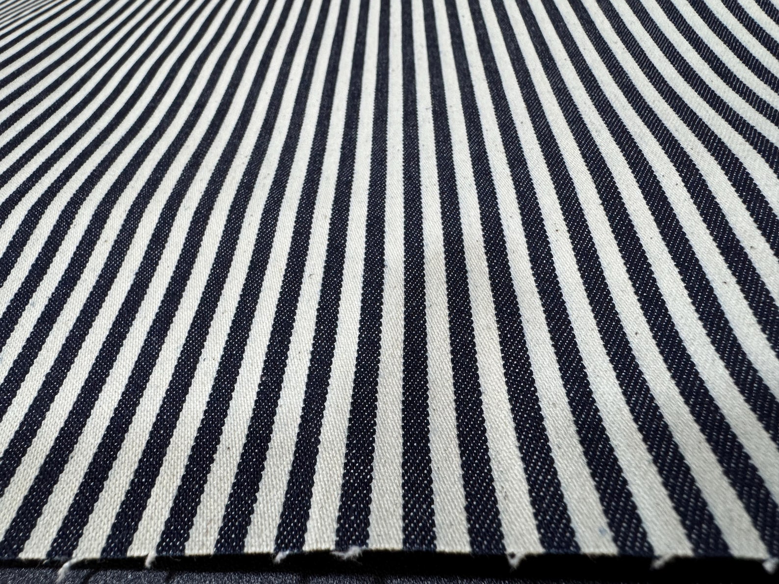 Close-up view of Okayama Denim fabric featuring navy and white stripes.