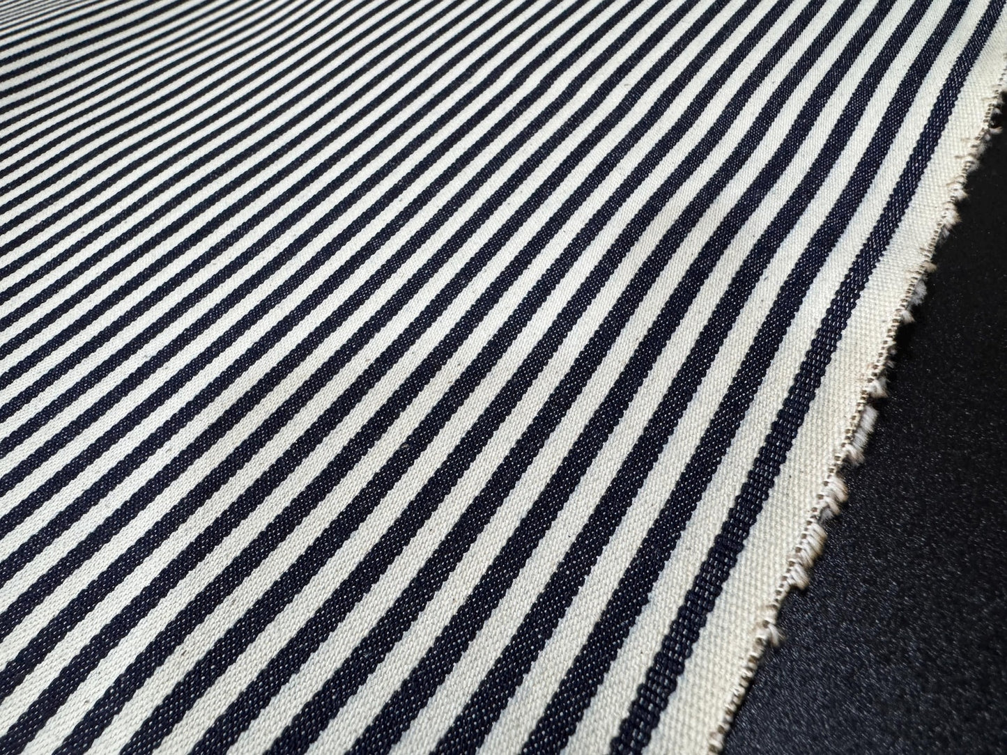 Okayama Denim - 10oz Double Width Indigo Hickory fabric with navy and cream stripes, ideal for sewing and crafting.