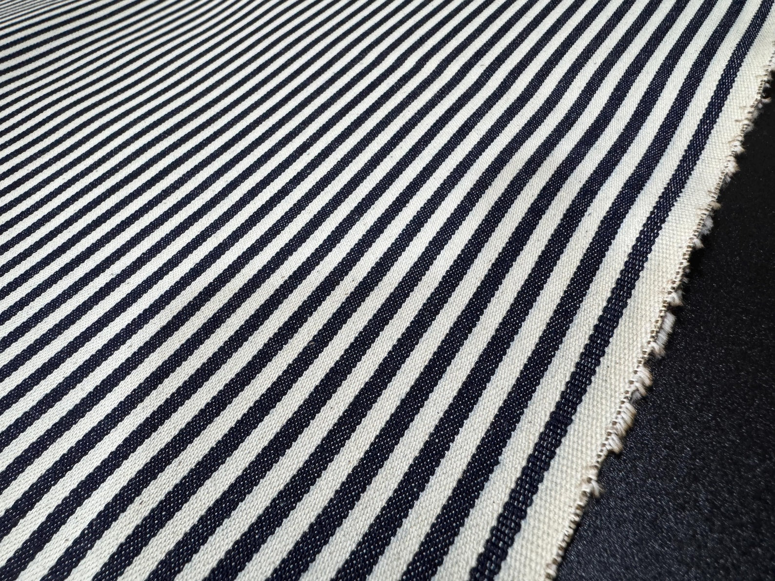 Okayama Denim - 10oz Double Width Indigo Hickory fabric with navy and cream stripes, ideal for sewing and crafting.